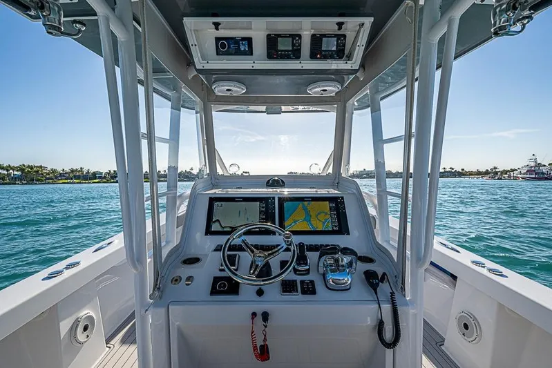  Yacht Photos Pics 2021 Albury Brothers 33 boat helm with navigation screens and controls on open water.