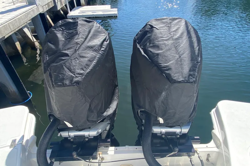  Yacht Photos Pics Covered outboard motors on a 2021 Boston Whaler 280 Vantage boat at a dock.