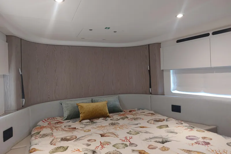 El Bibes Yacht Photos Pics Luxurious bedroom interior of 2023 Azimut Fly 53 yacht with elegant bedding and modern design.