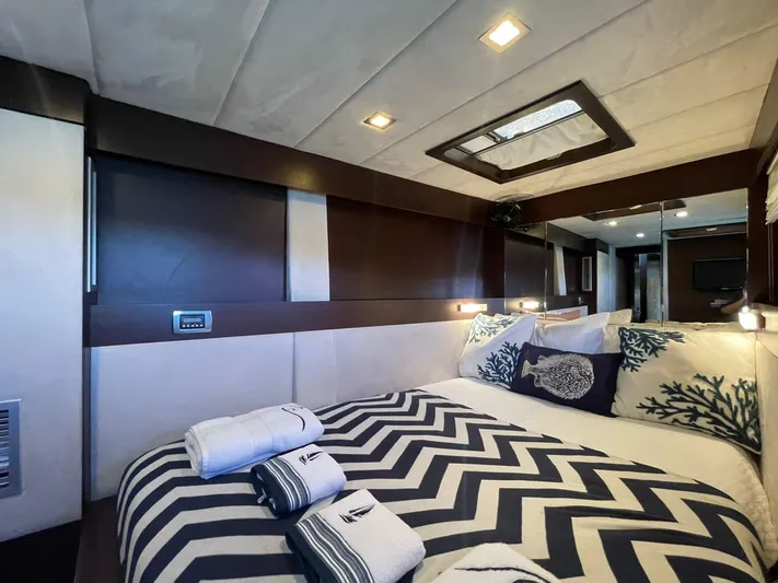 Pelicano Yacht Photos Pics Luxurious bedroom interior of 2009 Sunreef 62 yacht with modern decor and cozy bedding.