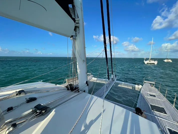 Pelicano Yacht Photos Pics 2009 Sunreef 62 catamaran sailing on open water with clear blue skies.