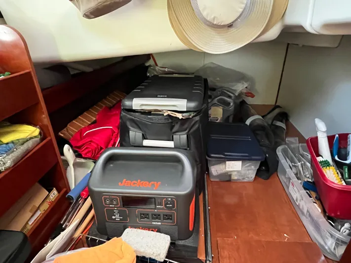 Vita Amoris Yacht Photos Pics Storage area in a 2005 Beneteau 423 sailboat with Jackery power station and organized supplies.