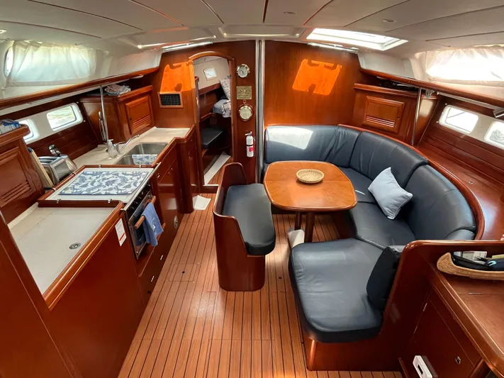 Vita Amoris Yacht Photos Pics Interior of a 2005 Beneteau 423 yacht with wood finish and cozy seating area.