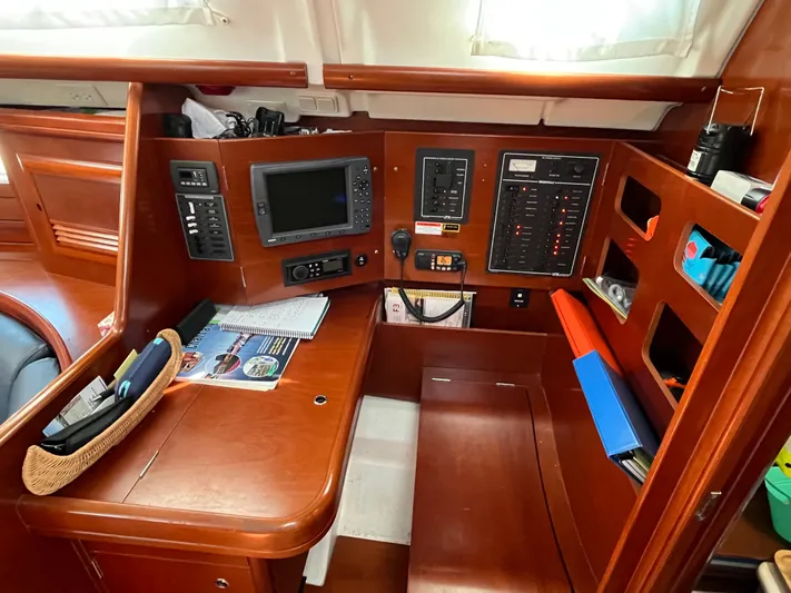 Vita Amoris Yacht Photos Pics Navigation station of 2005 Beneteau 423 yacht with control panels and equipment.