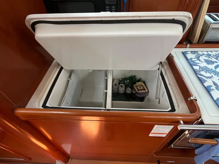 Vita Amoris Yacht Photos Pics Open refrigerator in 2005 Beneteau 423 yacht galley, stocked with drinks and food.