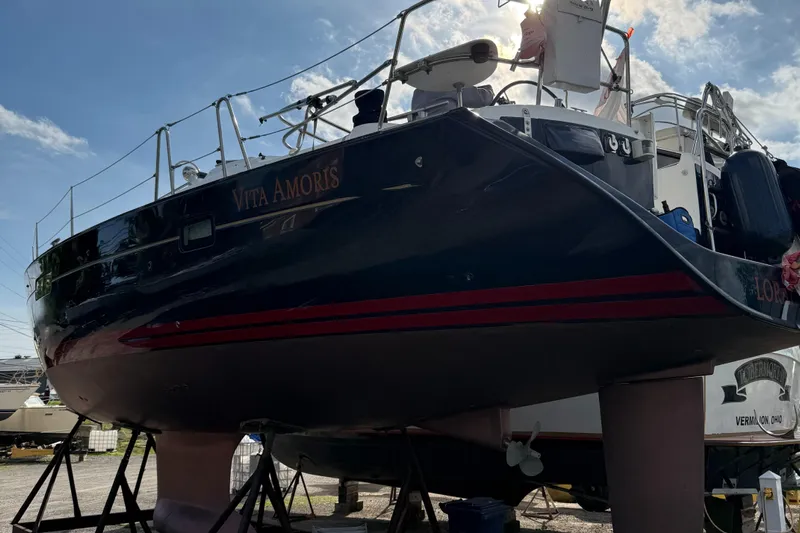 Vita Amoris Yacht Photos Pics 2005 Beneteau 423 sailboat "Vita Amoris" on dry dock under a clear blue sky.