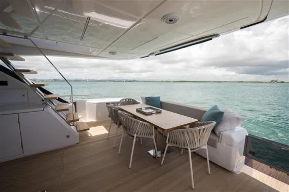  Yacht Photos Pics Luxurious 2023 Ferretti Yachts 720 deck with elegant seating and ocean view.