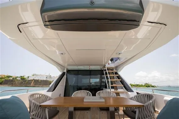  Yacht Photos Pics 2023 Ferretti Yachts 720 deck with dining area and stairs, overlooking the sea.