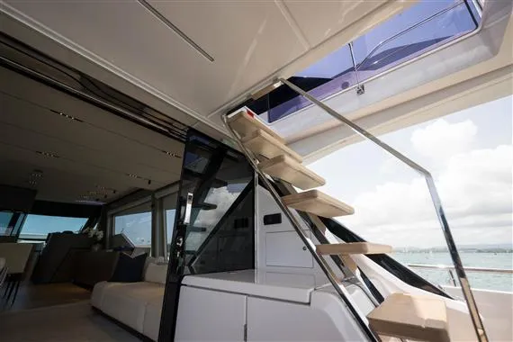  Yacht Photos Pics Luxurious interior of 2023 Ferretti Yachts 720 with modern staircase and ocean view.