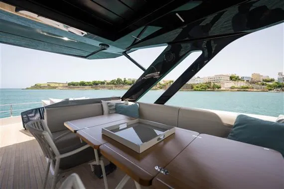  Yacht Photos Pics Luxurious 2023 Ferretti Yachts 720 deck with elegant seating and scenic waterfront view.