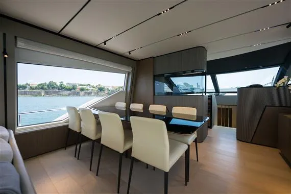  Yacht Photos Pics Luxurious interior of 2023 Ferretti Yachts 720 with elegant dining area and scenic window view.