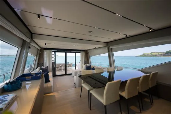  Yacht Photos Pics Luxurious interior of 2023 Ferretti Yachts 720 with ocean view and elegant dining area.