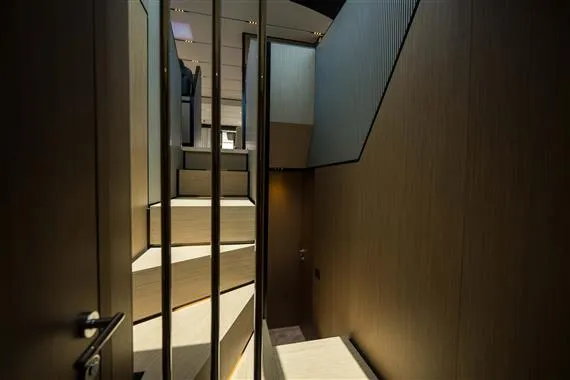  Yacht Photos Pics Interior staircase of 2023 Ferretti Yachts 720, featuring modern design and wood paneling.