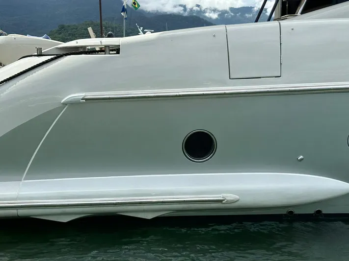 B-enjoy III Yacht Photos Pics Side view of a 2012 Azimut 72S yacht docked in a marina.