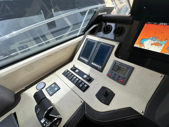 B-enjoy III Yacht Photos Pics Control panel of a 2012 Azimut 72S yacht with navigation screens and controls.