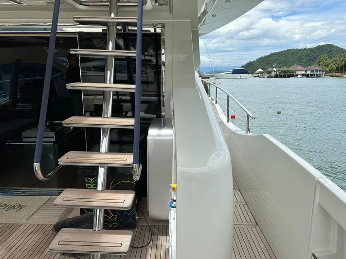 B-enjoy III Yacht Photos Pics Luxury Azimut 72S yacht deck with stairs, docked by scenic waterfront, 2012 model.