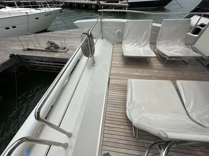 B-enjoy III Yacht Photos Pics Deck of a 2012 Azimut 72S yacht with lounge chairs at a marina.