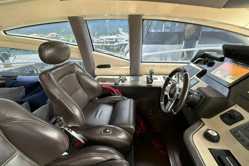 B-enjoy III Yacht Photos Pics Interior helm of 2012 Azimut 72S yacht with leather captain's chair and advanced navigation system.