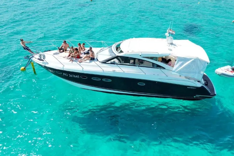  Yacht Photos Pics 2016 Princess V45 yacht with people relaxing on deck in clear turquoise water.