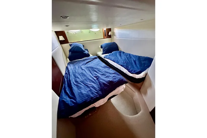  Yacht Photos Pics Twin beds in a 2016 Princess V45 yacht cabin with blue bedding.
