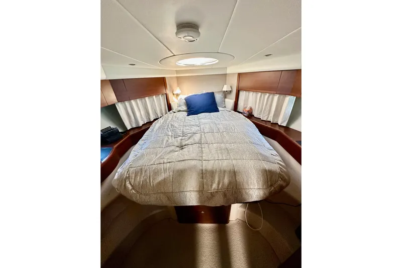  Yacht Photos Pics Luxurious cabin interior of 2016 Princess V45 yacht with cozy bed and elegant decor.