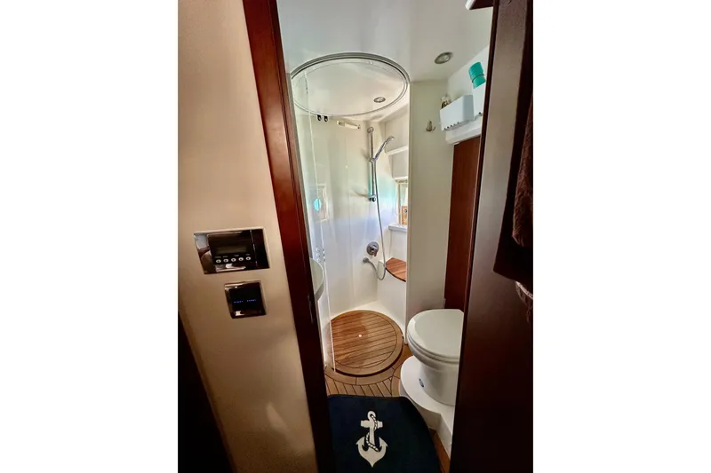  Yacht Photos Pics Luxurious bathroom in 2016 Princess V45 yacht with modern shower and wooden flooring.