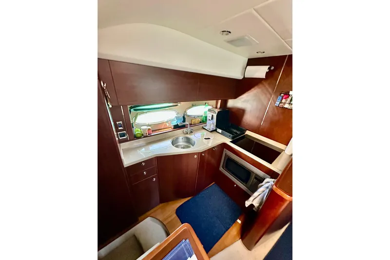  Yacht Photos Pics Luxurious 2016 Princess V45 yacht kitchen with modern amenities and elegant wood finish.