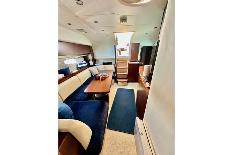  Yacht Photos Pics Luxurious interior of 2016 Princess V45 yacht with elegant seating and wooden table.