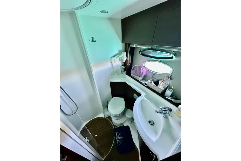  Yacht Photos Pics Bathroom interior of 2016 Princess V45 yacht, featuring modern fixtures and porthole window.
