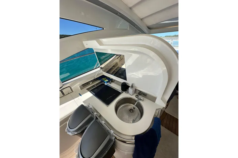  Yacht Photos Pics 2016 Princess V45 yacht kitchenette with sink, stove, and ocean view.