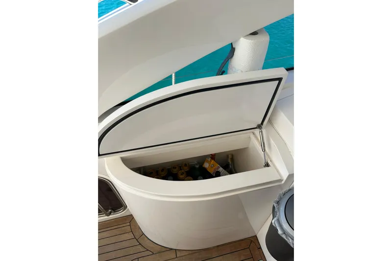  Yacht Photos Pics Open storage compartment on 2016 Princess V45 yacht, containing beverages, with ocean view.