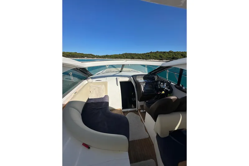  Yacht Photos Pics 2016 Princess V45 yacht interior with helm, seating, and scenic water view.