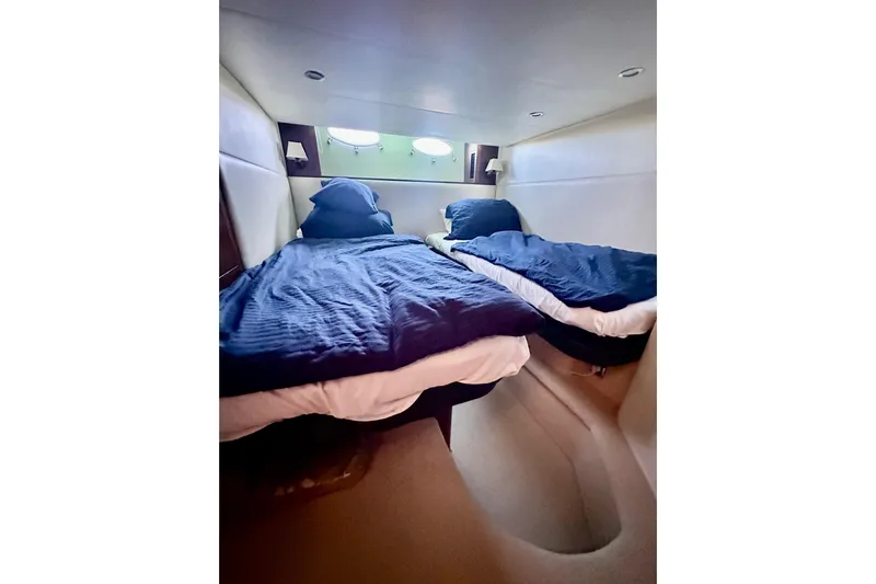  Yacht Photos Pics Twin beds in a 2016 Princess V45 yacht cabin with blue bedding.