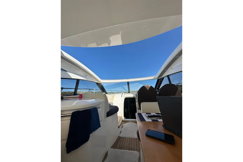  Yacht Photos Pics Interior view of 2016 Princess V45 yacht with open roof and modern seating.