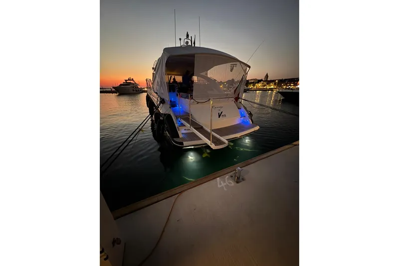  Yacht Photos Pics 2016 Princess V45 yacht docked at sunset with illuminated deck and calm waters.