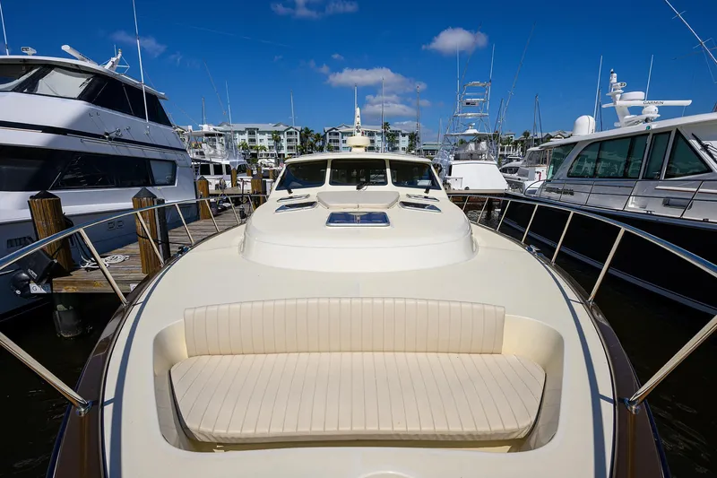 Nauti Dog Yacht Photos Pics 2023 Palm Beach Motor Yachts PB55 docked, showcasing sleek design and luxurious seating.