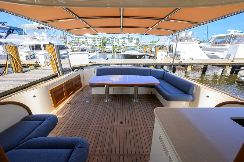 Nauti Dog Yacht Photos Pics 2023 Palm Beach Motor Yachts PB55 interior with spacious seating and elegant wood finish.