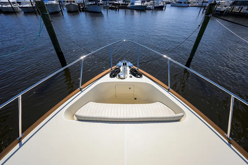 Nauti Dog Yacht Photos Pics 2023 Palm Beach Motor Yachts PB55 bow view at marina, showcasing sleek design and luxury.