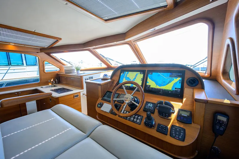 Nauti Dog Yacht Photos Pics 2023 Palm Beach Motor Yachts PB55 helm with modern navigation systems and luxurious interior.
