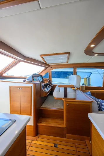 Nauti Dog Yacht Photos Pics Luxurious interior of 2023 Palm Beach Motor Yachts PB55, featuring elegant wood finishes.
