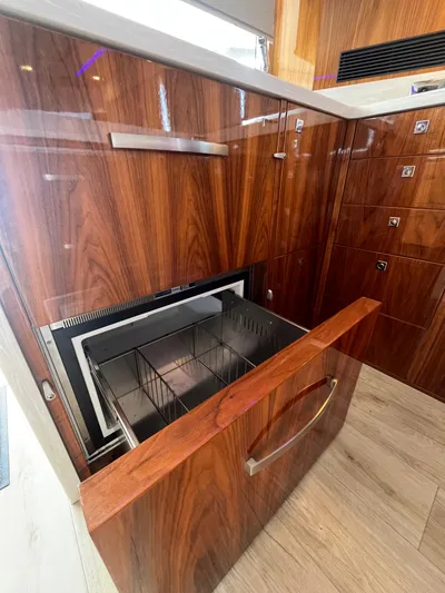 Mon Trésor Yacht Photos Pics Luxury yacht interior with wood finish and built-in drawer storage, Riviera 6000 Sport Yacht Platinum Edition 2020.