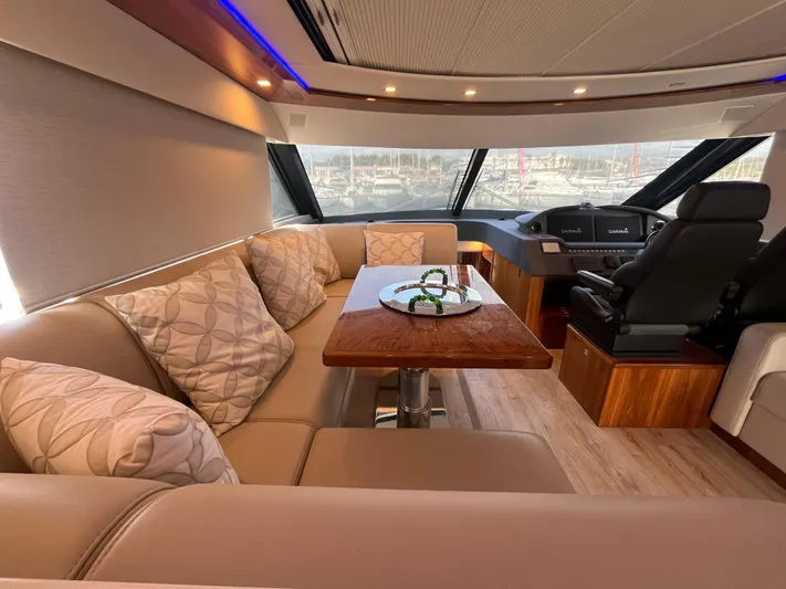 Mon Trésor Yacht Photos Pics Luxurious interior of 2020 Riviera 6000 Sport Yacht Platinum Edition with plush seating and elegant decor.