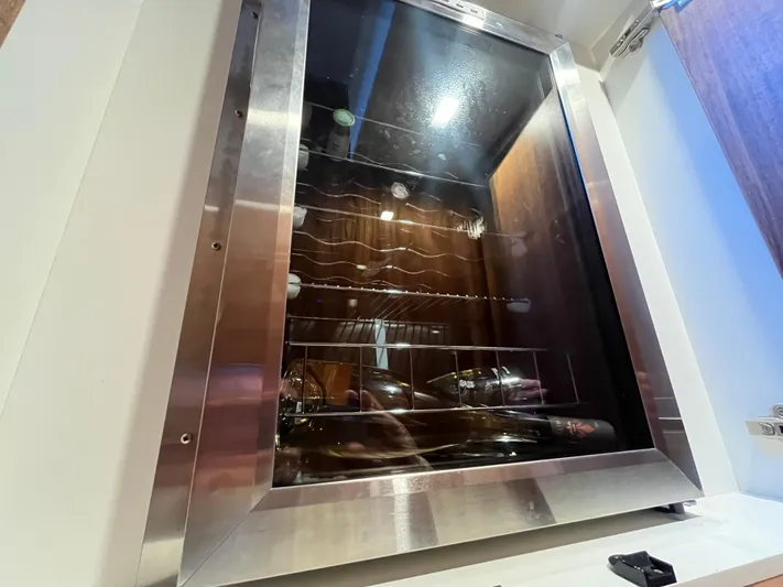 Mon Trésor Yacht Photos Pics Wine cooler inside 2020 Riviera 6000 Sport Yacht Platinum Edition, showcasing luxury interior features.