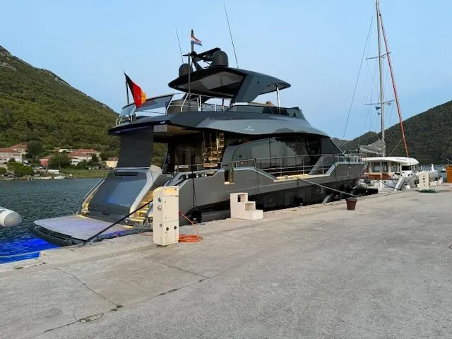  Yacht Photos Pics 2024 Cranchi Sessantasette 67 yacht docked in a scenic marina setting.