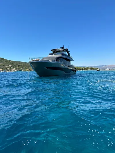  Yacht Photos Pics 2024 Cranchi Sessantasette 67 yacht on clear blue water under a bright sky.