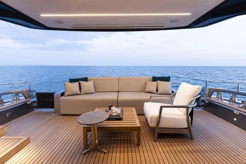 Yacht Photos Pics Luxurious deck of 2024 Cranchi Sessantasette 67 yacht with ocean view and elegant seating.
