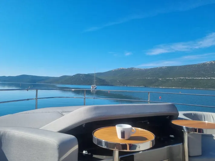  Yacht Photos Pics Luxurious 2024 Cranchi Sessantasette 67 yacht deck with scenic ocean view.