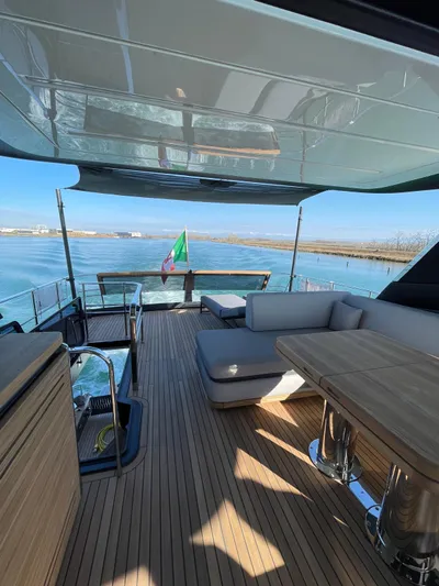  Yacht Photos Pics Luxurious 2024 Cranchi Sessantasette 67 yacht deck with elegant seating and scenic water view.