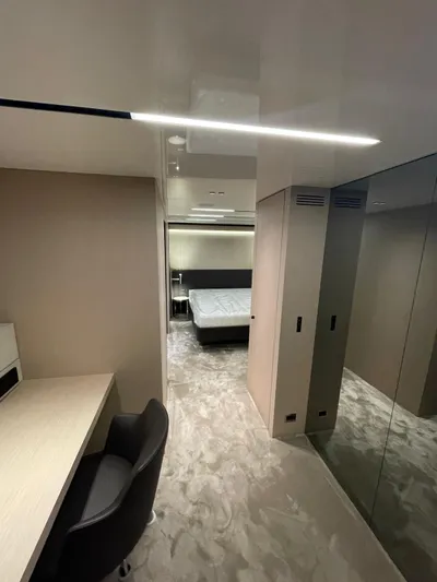  Yacht Photos Pics Luxurious interior of 2024 Cranchi Sessantasette 67 yacht with modern bedroom and workspace.