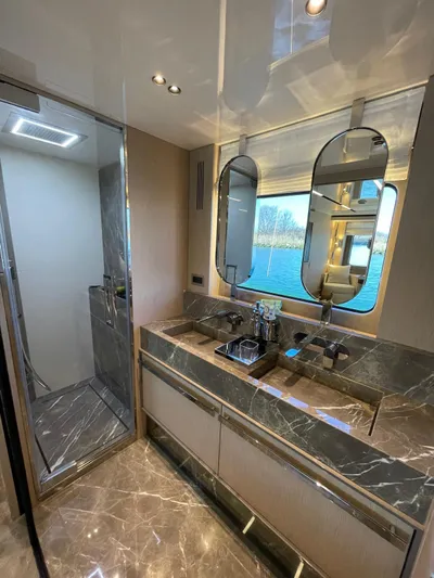  Yacht Photos Pics Luxurious bathroom in 2024 Cranchi Sessantasette 67 yacht with marble finishes and modern fixtures.